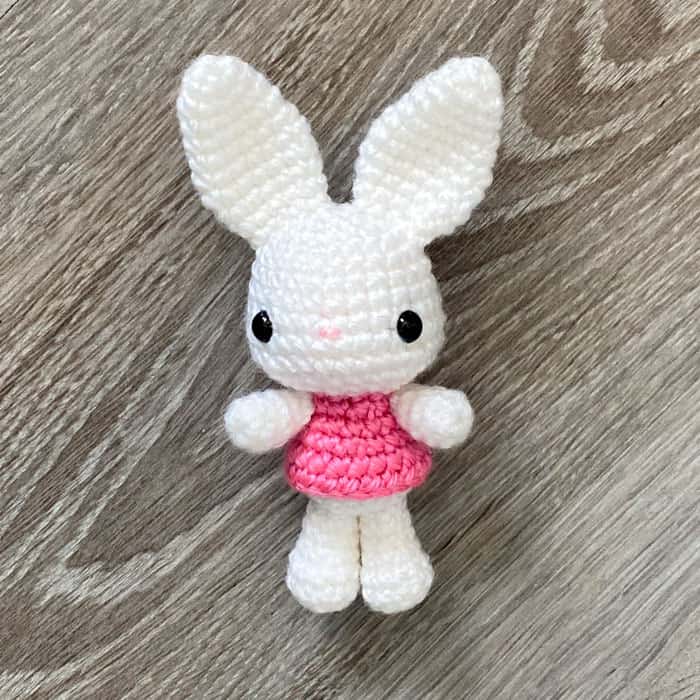 white bunny amigurumi with a pink dress